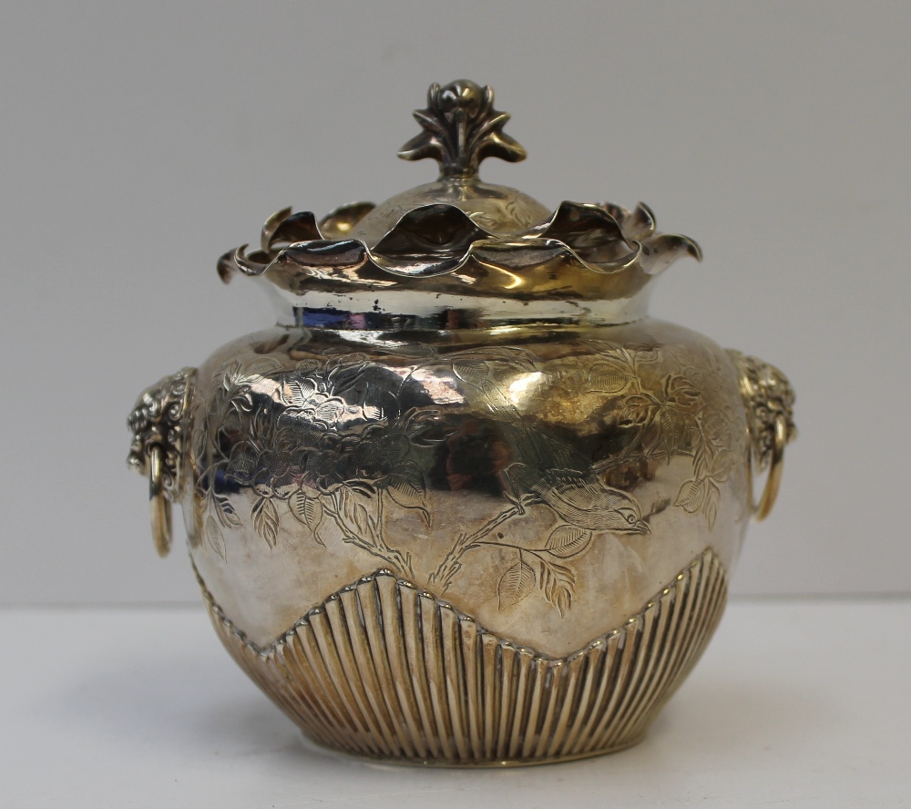 A Chinese white metal Sucrier and cover with a wave rim, and floral finial, the wave ribbed body