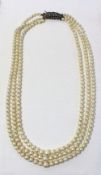 A three strand pearl necklace with graduated pearls to a marcasite clasp together with another pearl