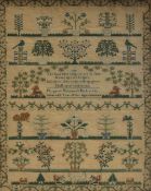 An early 19th century sampler decorated with trees, birds, stags, vase of flowers, "1933 The soul