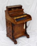 A Victorian walnut piano topped Davenport, the rising top with a stationery compartment, to a hinged