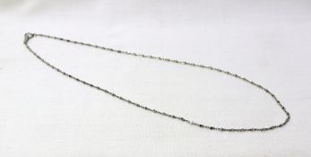 A platinum necklace with cube and oval shaped links, approximately 5 grams