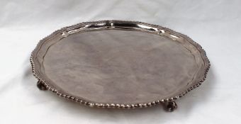 An Elizabeth II silver salver of lobed form with a gadrooned edge on scrolling feet, 32cm