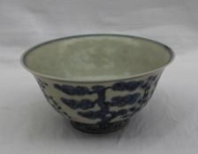 An 18th century Chinese bowl, decorated with a tree and bushes to the centre, the outside edge