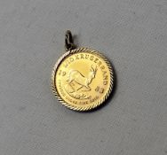A 1983 1/10th gold krugerrand in a 9ct yellow gold slip mount