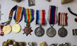 A set of World War I medals including The British War Medal, Victory Medal, and 1914-15 Star