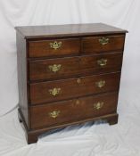 A 19th century oak chest, the rectangular top above two short and three long drawers on bracket