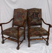 A pair of 19th century walnut elbow chairs with leaf carved arms on turned legs and hairy paw feet