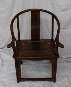 A Chinese hardwood elbow chair with a rectangular splat and outswept arms, a rectangular seat on