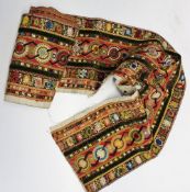 A printed cotton strip embellished with wool, gold thread, velvet, satin and silk, 190cm long x 21.