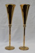 A pair of Elizabeth II silver gilt champagne flutes, with a knopped stem on a spreading foot,