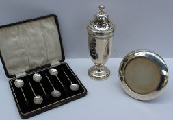 A George V silver sugar sifter,with a turned finial and pierced domed top above a panelled body