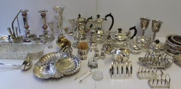 An electroplated epergne together with electroplated candlesticks, bottle coasters, toast rack,