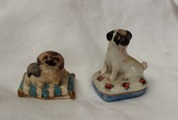 A Basil Matthews model of a pug seated on a cushion 6.5cm high together with another of a