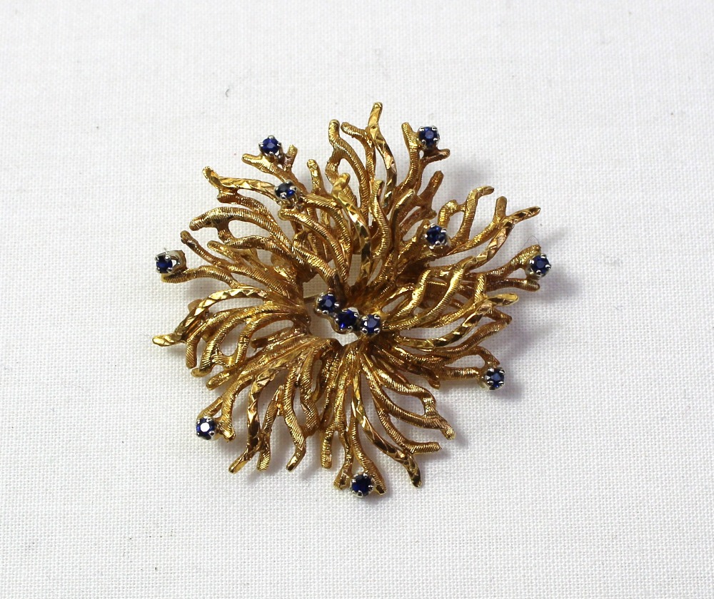 An 18ct yellow gold brooch of naturalistic form set with twelve sapphires approximately 13 grams