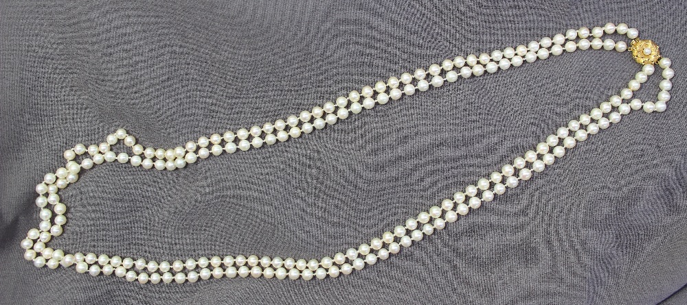 A double string of two hundred and twenty regular spherical pearls individually knotted on a 9ct - Image 2 of 3