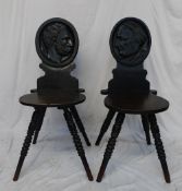 A pair of 19th century oak hall chairs, the oval backs carved with side on portraits titled "Humbert