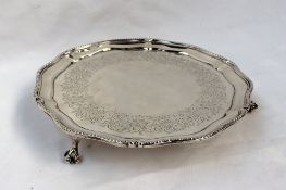 A Victorian silver waiter, the beaded rim above a flower engraved plate on claw and ball feet,