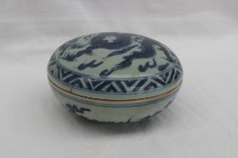 A 19th century Chinese blue and white porcelain circular box and cover, decorated with a dragon