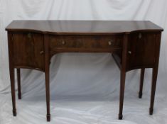 A 19th century mahogany sideboard, the shaped top above a central drawer and two cupboards on square
