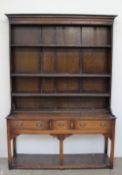 A 19th century oak South Wales dresser, the closed rack with three shelves, the base with three