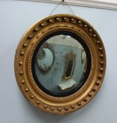 A Victorian gilt and ball decorated convex wall mirror, 55cm diameter