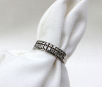 An 18ct white gold ring set with two rows of nine brilliant cut diamonds