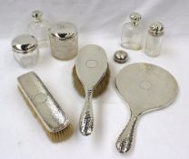 A George V silver part dressing table set, comprising hair brush, clothes brush, hand mirror and