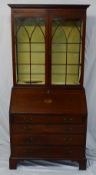 An Edwardian mahogany bureau bookcase, the moulded cornice above a pair of glazed doors with glazing