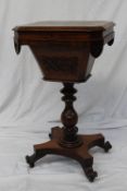 A Victorian rosewood work table, the hinged octagonal top with a bevelled edge, enclosing a