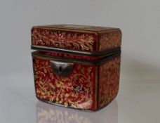 A 19th century cranberry glass trinket box and cover decorated to the top with a vignette of