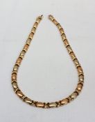 An 18ct yellow gold textured oval and C scroll link necklace, approximately 27 grams