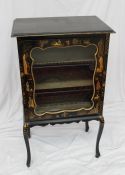 A black lacquer music cabinet with a glazed door and chinoiserie decorated door and sides on
