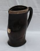 An Edwardian silver topped and leather jug with a stitched handle and stitched base, marked in an