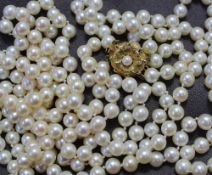 A double string of two hundred and twenty regular spherical pearls individually knotted on a 9ct