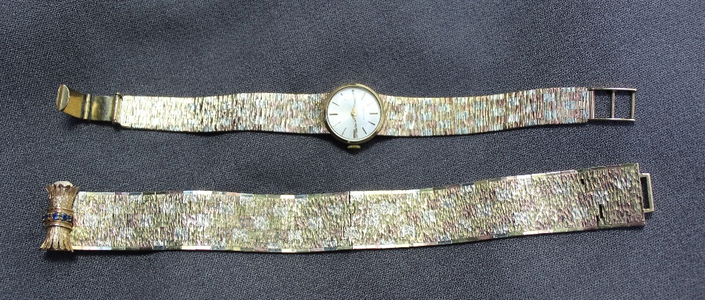 A 9ct yellow gold lady`s wristwatch the silvered dial with batons marked "Marvin" on a three