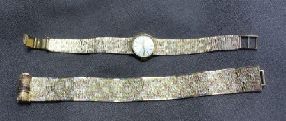 A 9ct yellow gold lady`s wristwatch the silvered dial with batons marked "Marvin" on a three