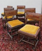 A set of six oak dining chairs with tooled leather back and seat on ring turned legs and flattened