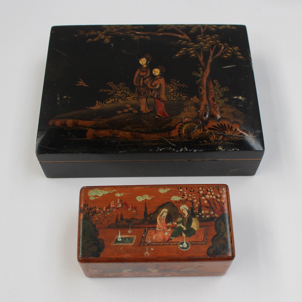 A rectangular hinged box painted with Indian figures seated taking tea in a garden setting, 9.5cm