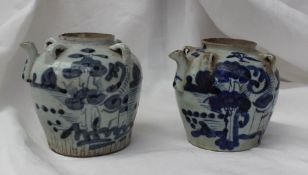 A matched pair of 19th century Chinese dynasty blue and white porcelain oil jugs with a pouring