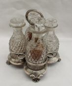 A George IV silver cruet bottle stand, with a leaf decorated ring handle, the base with line