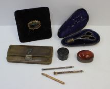 A white metal sewing set comprising a pair of scissors and a thimble, marked sterling, cased,