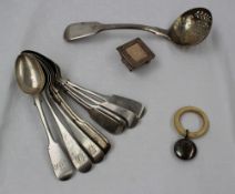 A George III silver fiddle pattern sifting spoon, the bowl pierced with arrows and scrolls,