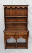 A reproduction South Wales oak dresser, the planked rack with two shelves above a rectangular top,