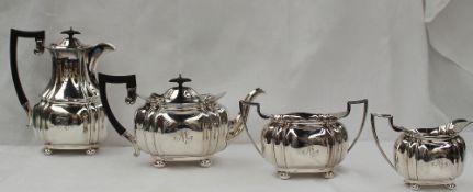 An Edward VII silver four piece teaset of oval lobed form on flattened bun feet, comprising hot