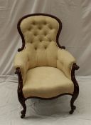 A Victorian mahogany Gentleman`s chair, the spoon back with button upholstery and a pad seat on