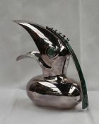 A white metal jug in the form of an open mouthed bird with a hardstone eye and handle, 29cm high