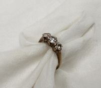 A three stone diamond ring set with brilliant cut diamonds totalling approximately 1 carat to a