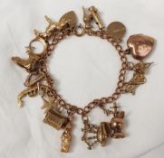 A 9ct yellow gold charm bracelet set with numerous charms including a bull, moon and star, boot,