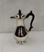 A late Victorian silver hot water pot of baluster form with a treen handle, Chester, 1898, Hillary &