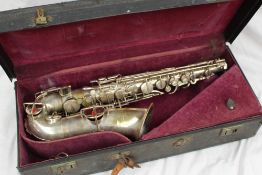 A Buescher Elkhart saxophone No. 196753, stamped True tone, low pitch in a lined base